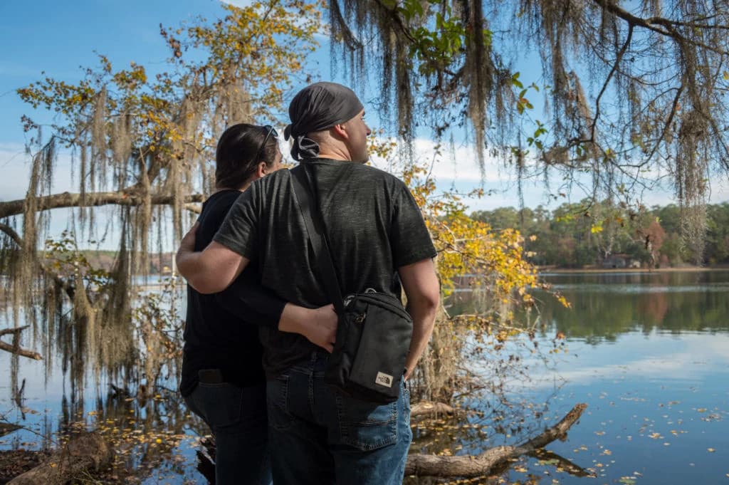 Team of professionals collaborating and discussing ideas around a table with digital devices and documents in a modern office