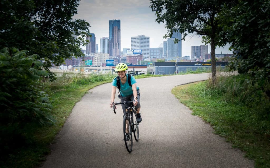 Portrait of Jovan, a confident professional man wearing a blue suit and white shirt against a neutral background