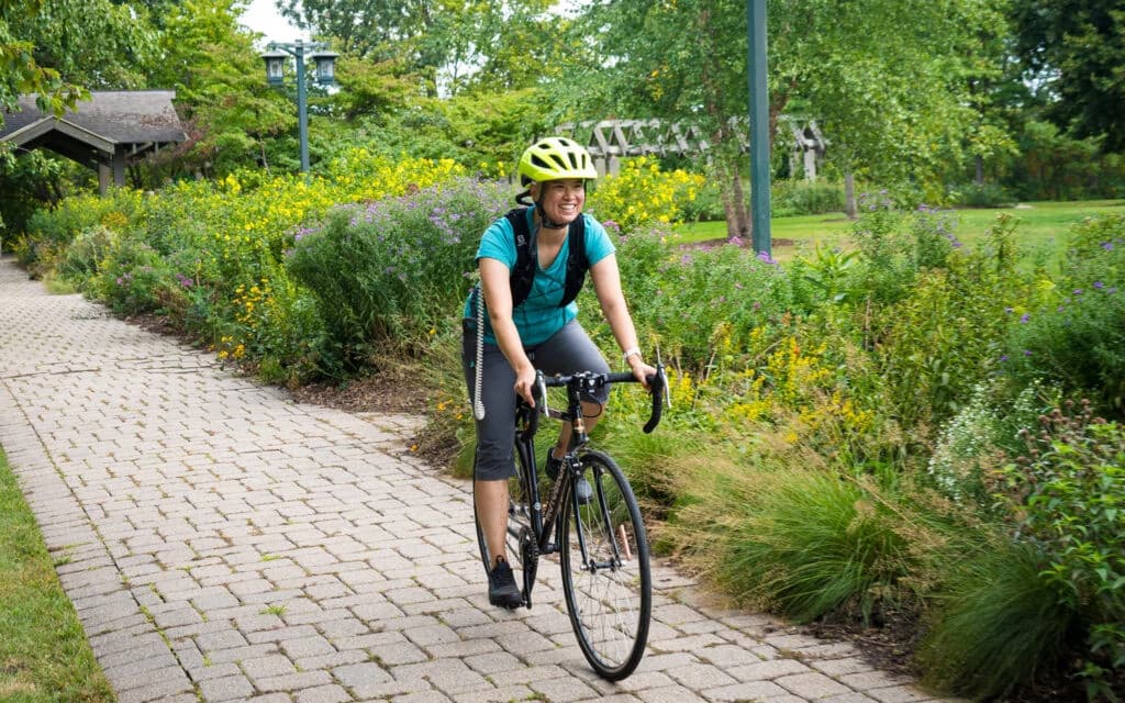 Portrait of Jovan, smiling professional in a navy blue suit and glasses